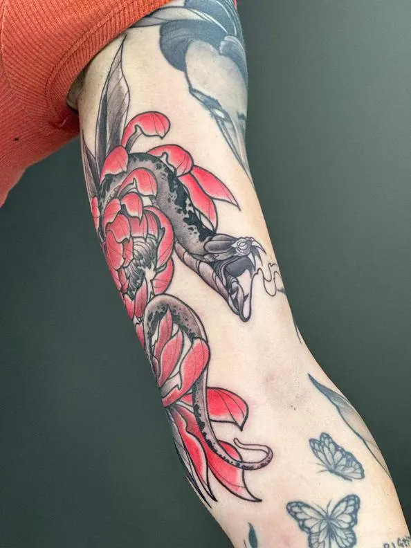 Red and black floral sleeve tattoo