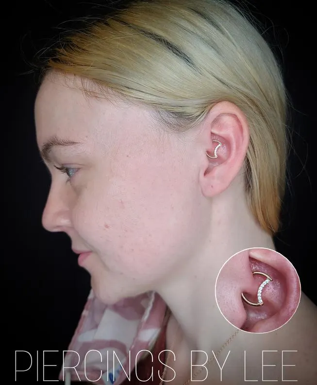 Ear piercing with a close-up of the jewelry